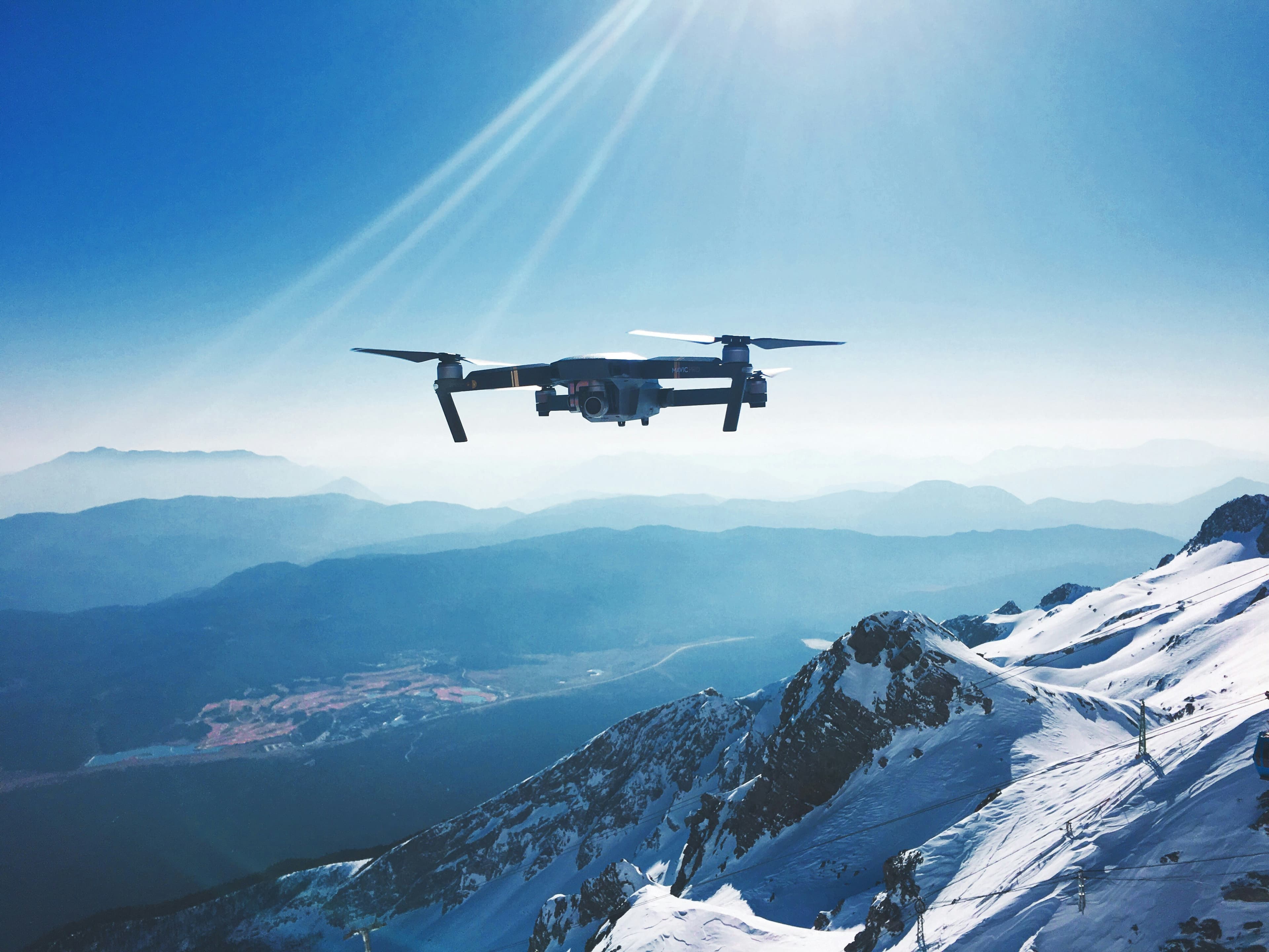 Drone flying above the snowy mountains